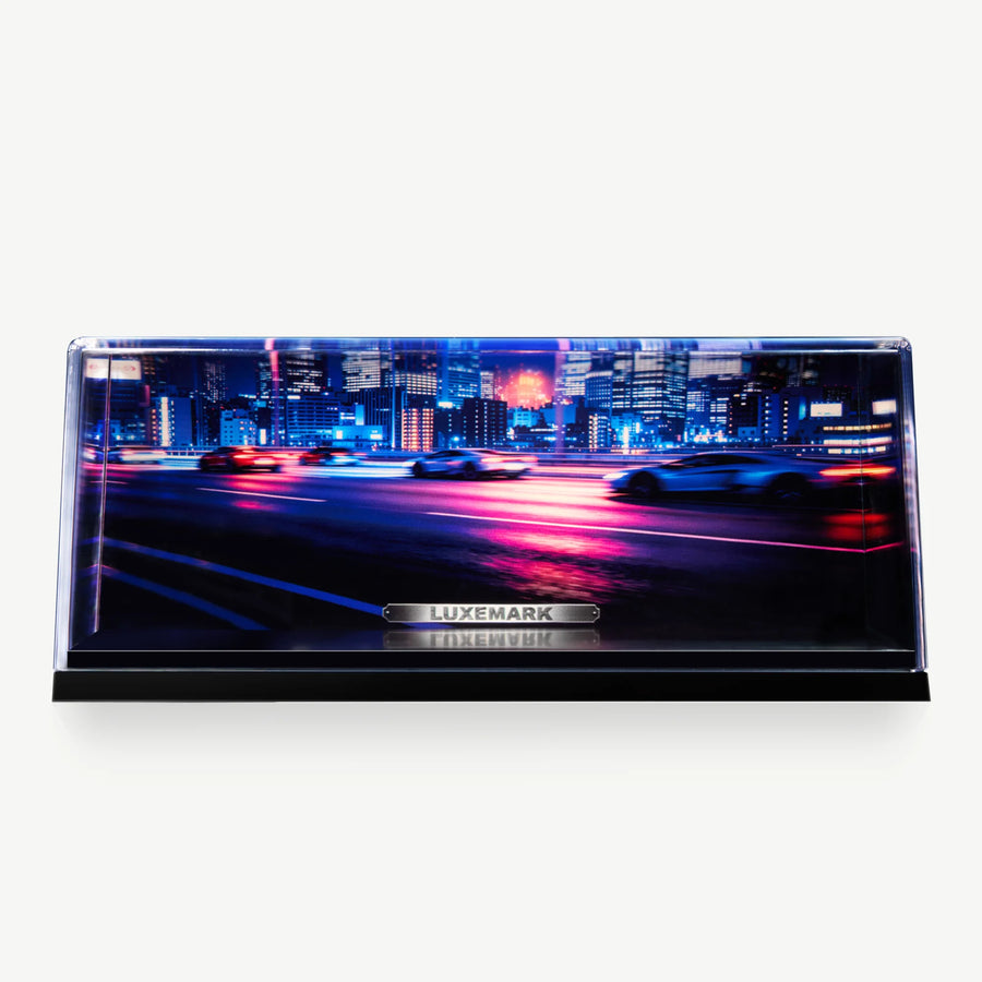 LUXEMARK Clear display case with a blue and magenta highway backdrop and a white model car shown for display