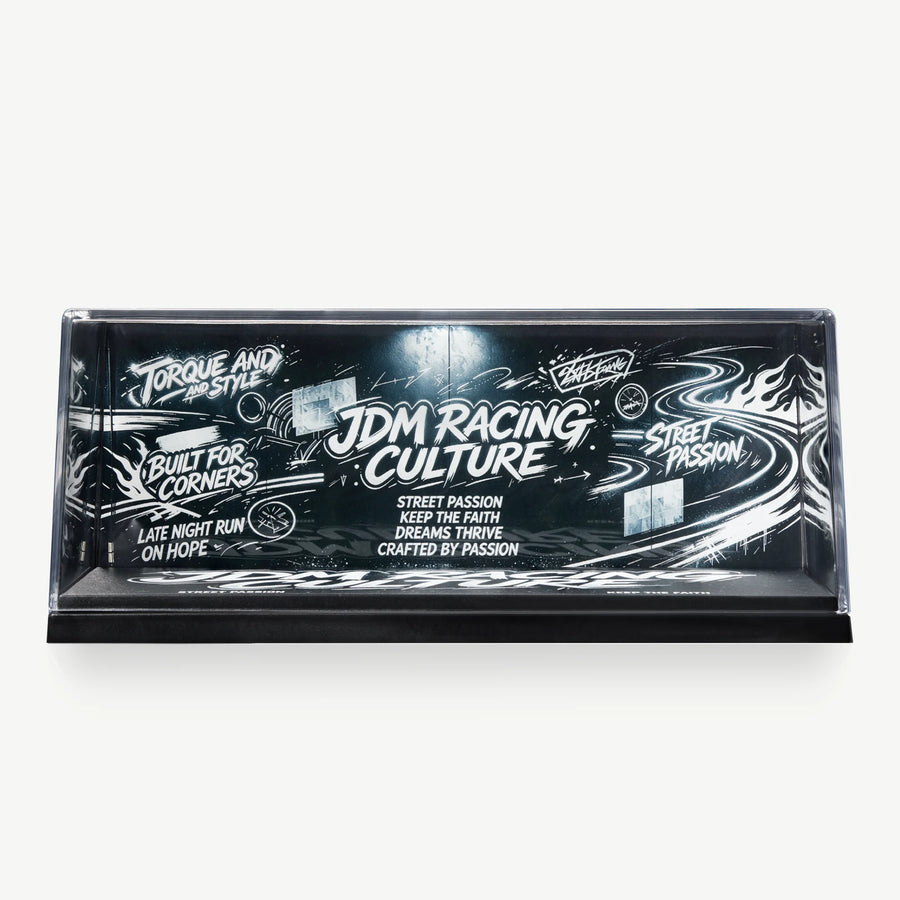 LUXEMARK Black-and-white JDM Racing Culture graphic backdrop inside a clear display case